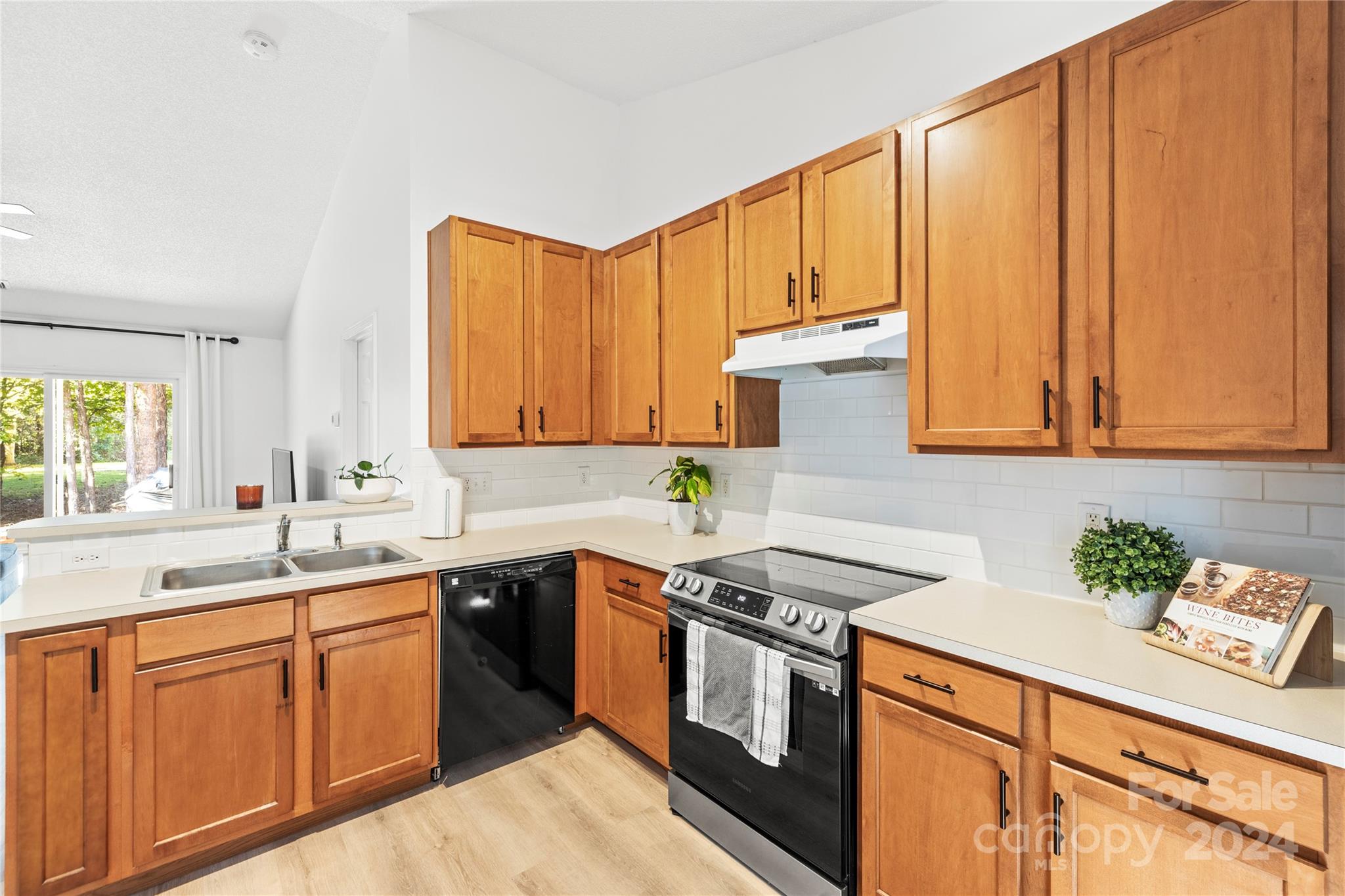 4909 Deerton Road Charlotte, NC 28269 - Photo 4 of 31 a kitchen with a sink stove and cabinets
