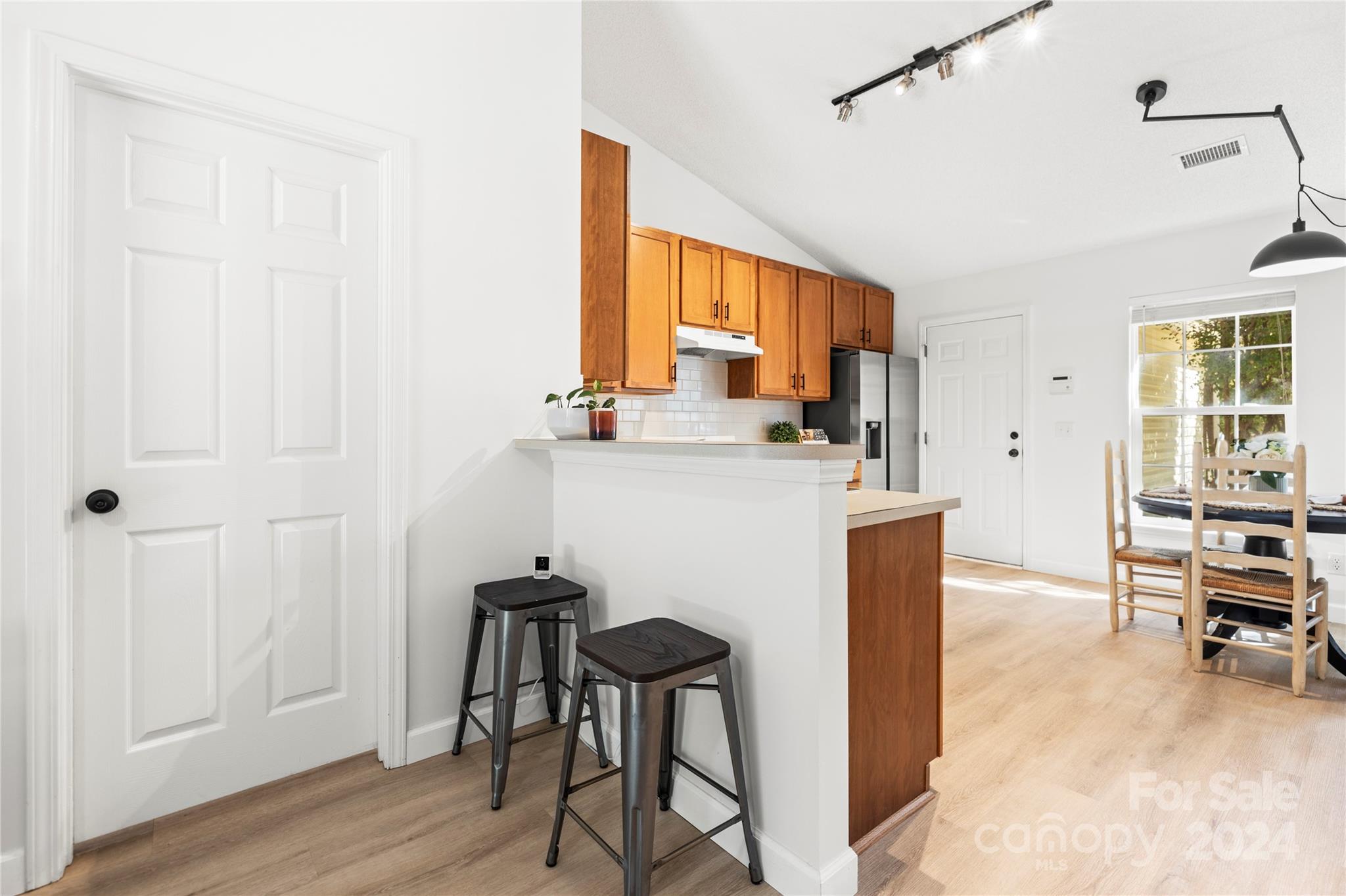 4909 Deerton Road Charlotte, NC 28269 - Photo 6 of 31 a view of kitchen with kitchen island dining table and chairs