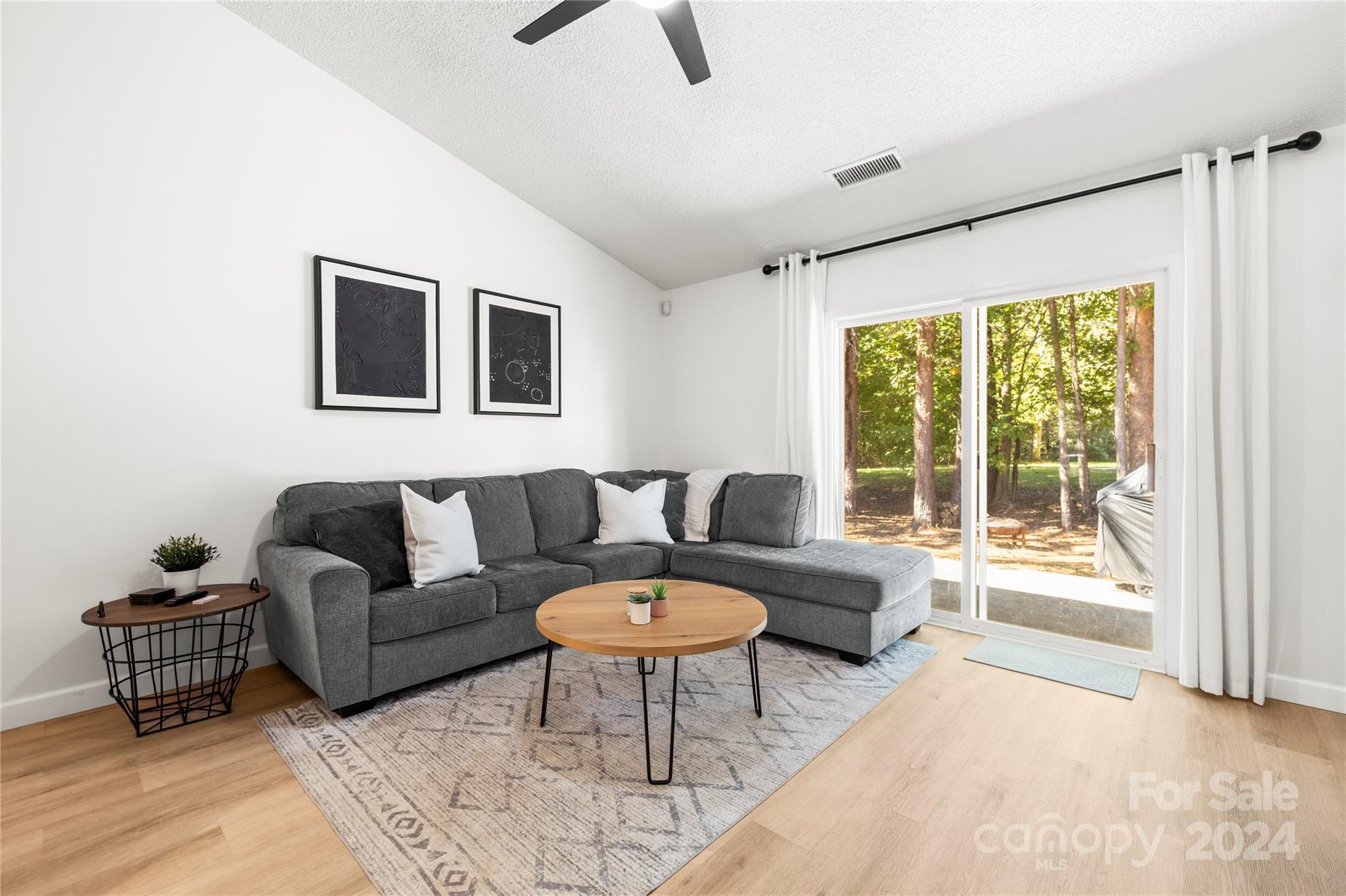 4909 Deerton Road Charlotte, NC 28269 - Photo 8 of 31 a living room with furniture and a large window