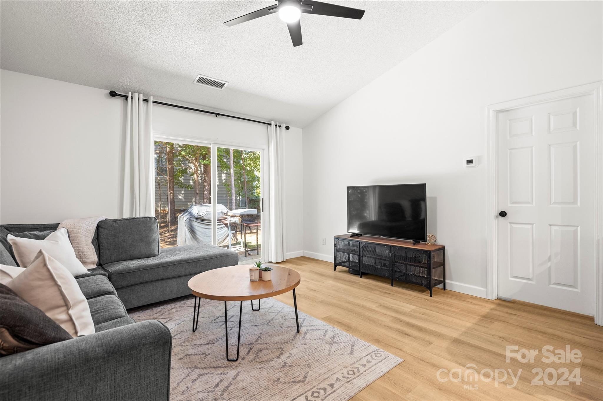 4909 Deerton Road Charlotte, NC 28269 - Photo 10 of 31 a living room with furniture and a flat screen tv
