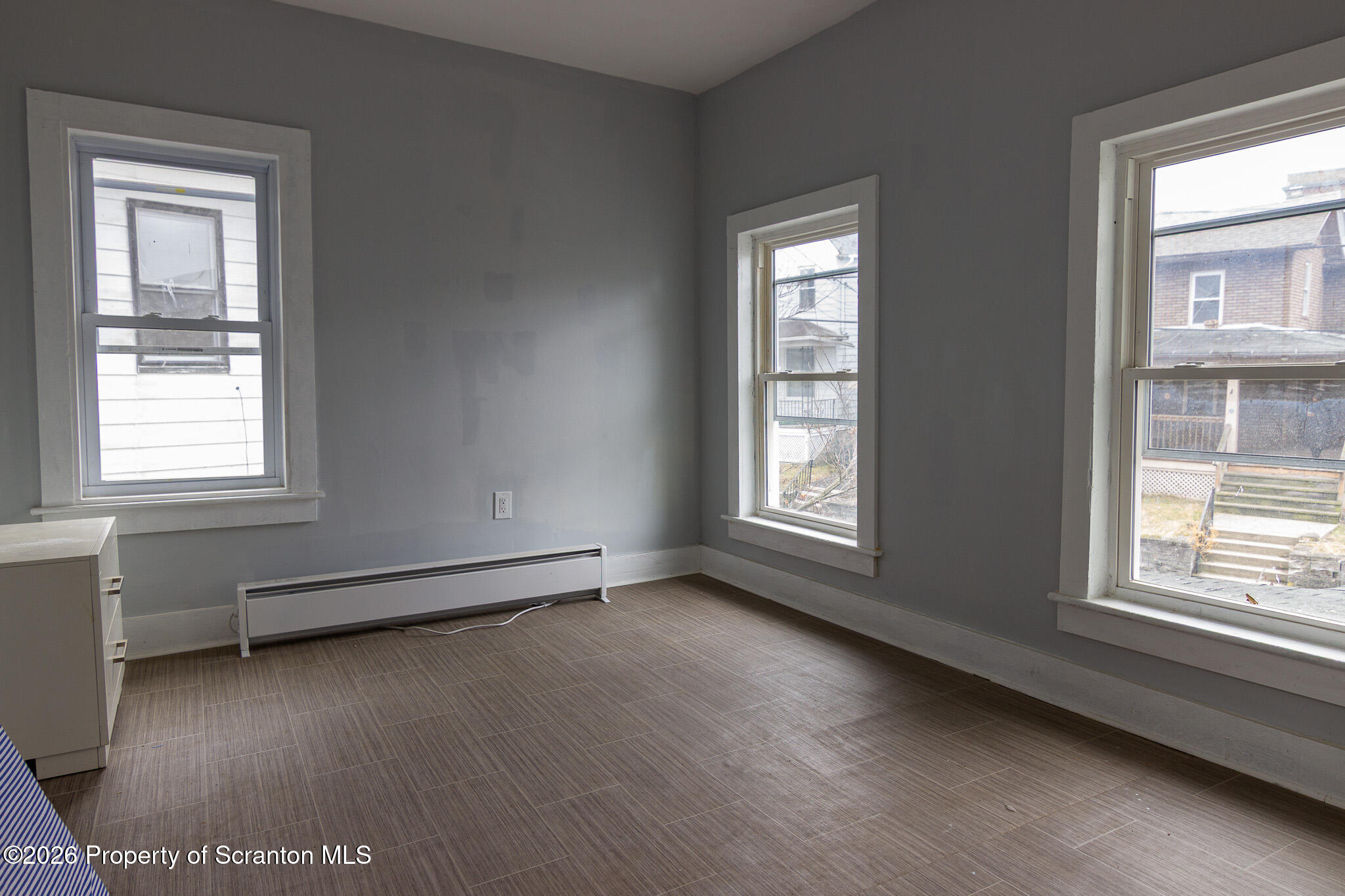 214 William Street Scranton, PA 18508 - Photo 18 of 33 a view of an empty room with wooden floor and a window