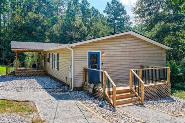 a view of backyard with deck and outdoor seating