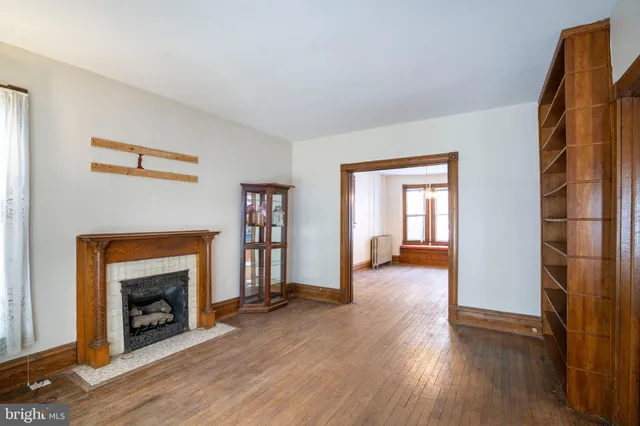 a living room with a fireplace and a rug
