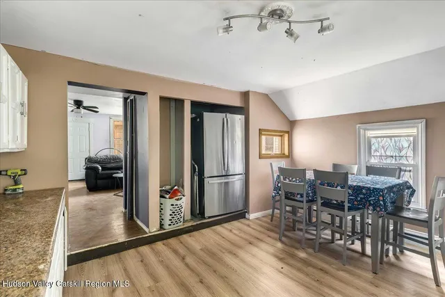 a view of a dining room with furniture window and wooden floor