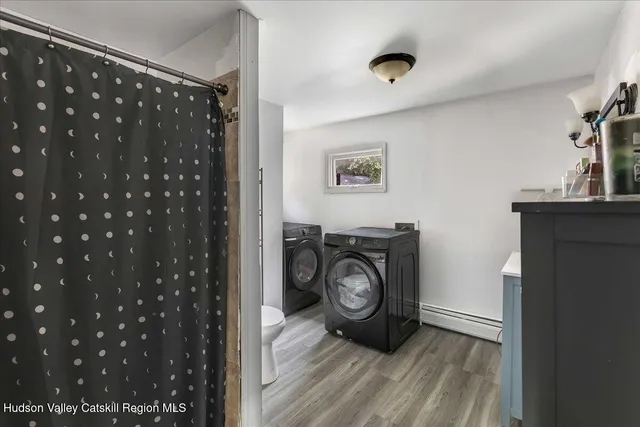 a view of a bedroom with washer and dryer