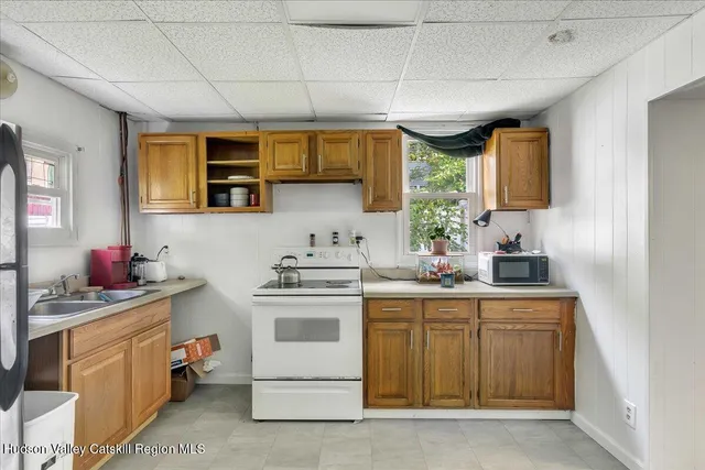 a kitchen with a sink stove and cabinets