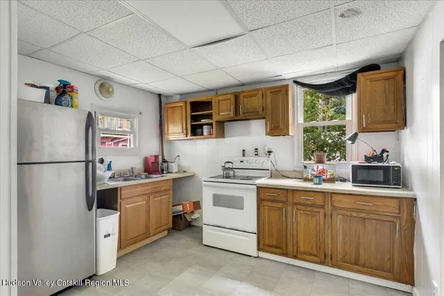 a kitchen with a sink stove and refrigerator