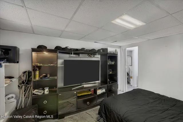 a bedroom with a bed and flat screen tv