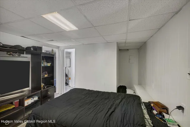 a bedroom with a bed and a flat tv screen