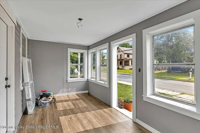 a living room with a large window and chandelier