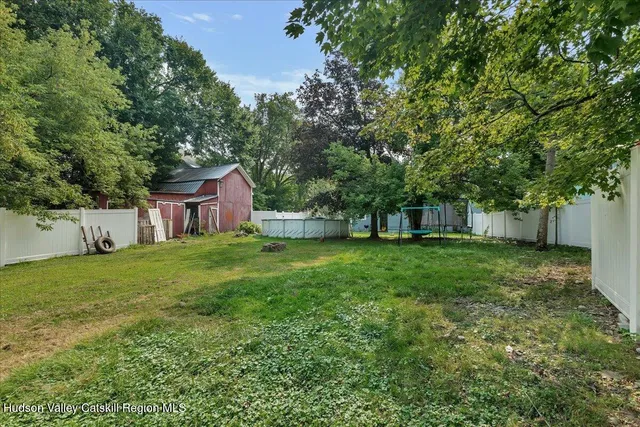 a view of a house with backyard and a sitting area