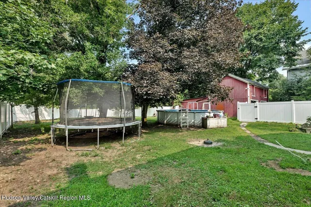 an aerial view of a house with backyard and outdoor seating