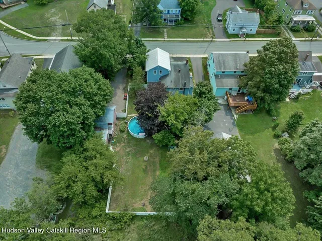 an aerial view of a house with pool outdoor seating and yard