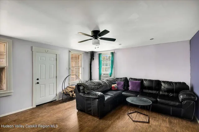 a living room with furniture and a ceiling fan