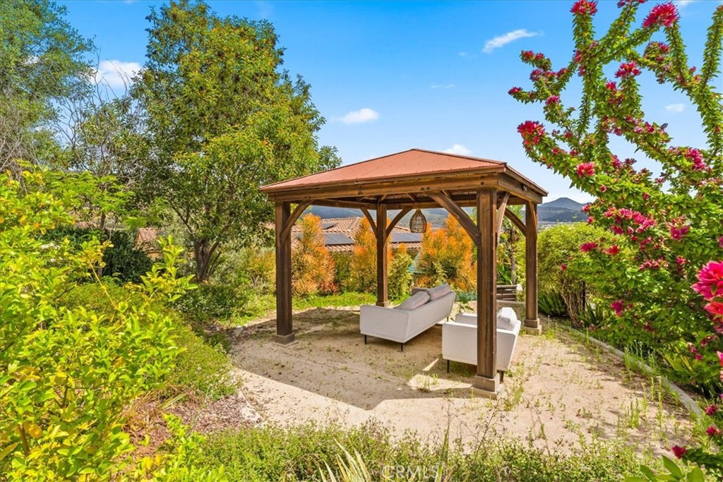 2836 Mesa Grove Road Fallbrook, CA 92028 - Photo 22 of 54 a backyard of a house with table and chairs