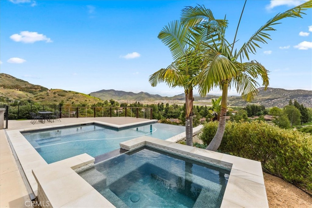 2836 Mesa Grove Road Fallbrook, CA 92028 - Photo 3 of 54 a view of a swimming pool with a table and chairs