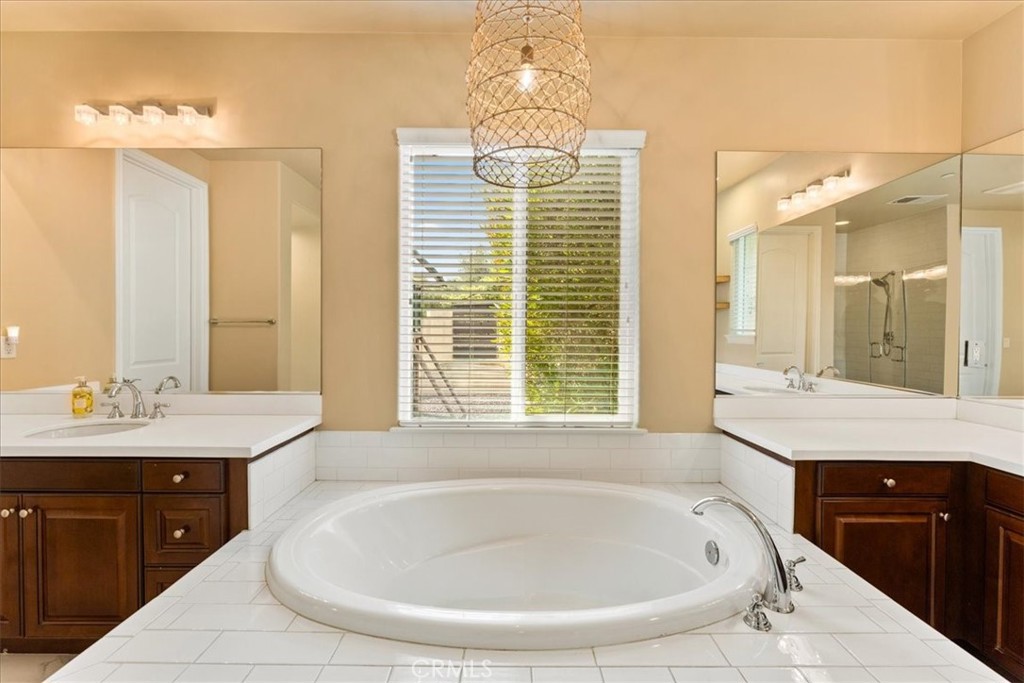 2836 Mesa Grove Road Fallbrook, CA 92028 - Photo 38 of 54 a spacious bathroom with a granite countertop tub sink and mirror