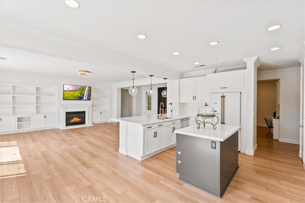 2836 Mesa Grove Road Fallbrook, CA 92028 - Photo 7 of 54 a large white kitchen with stainless steel appliances kitchen island a stove a refrigerator a sink dishwasher with a dining table and chairs