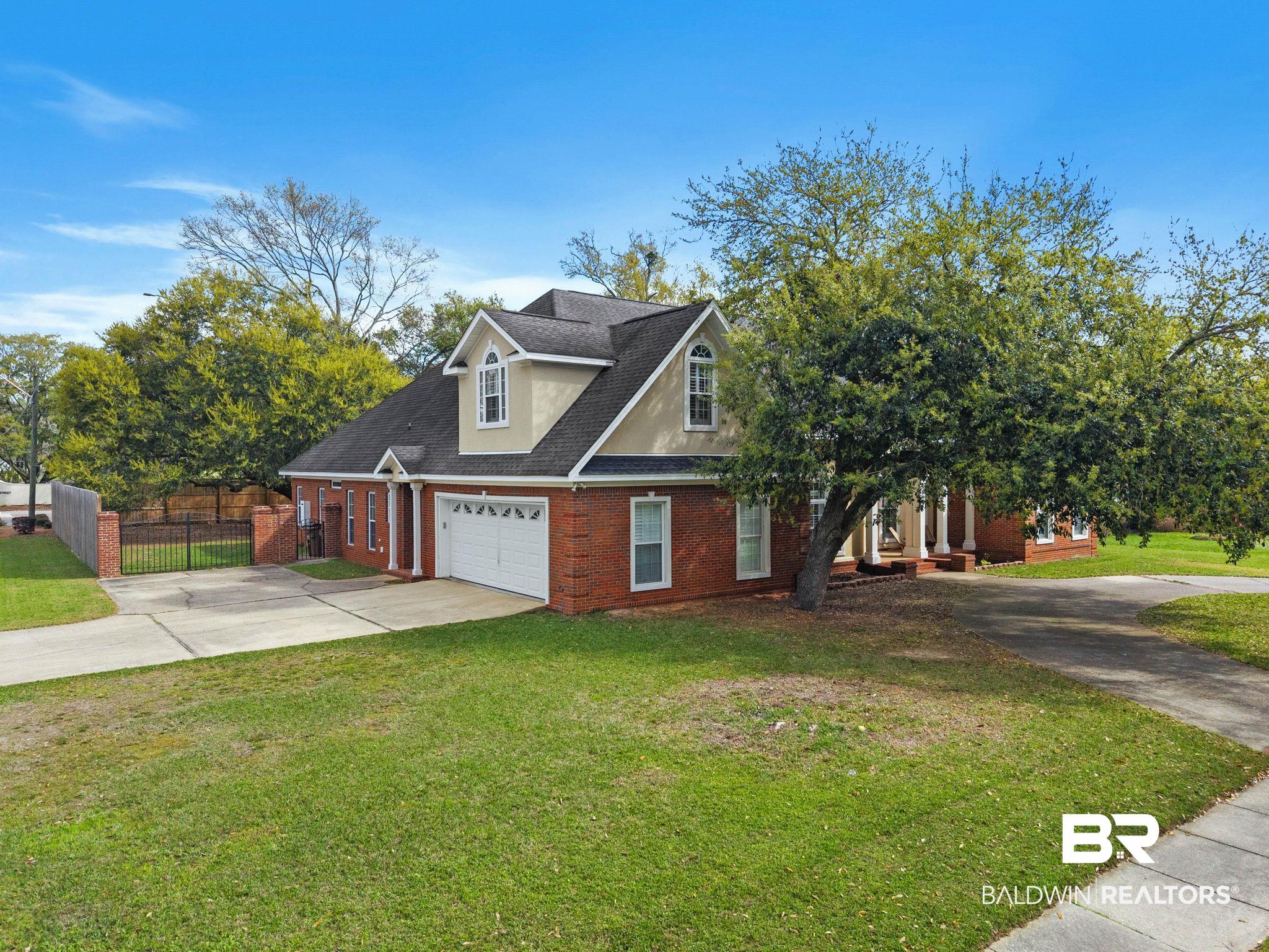 3668 Claridge Road North Mobile, AL 36608 - Photo 8 of 100 View of front of house featuring driveway, brick siding, a shingled roof, and a gate