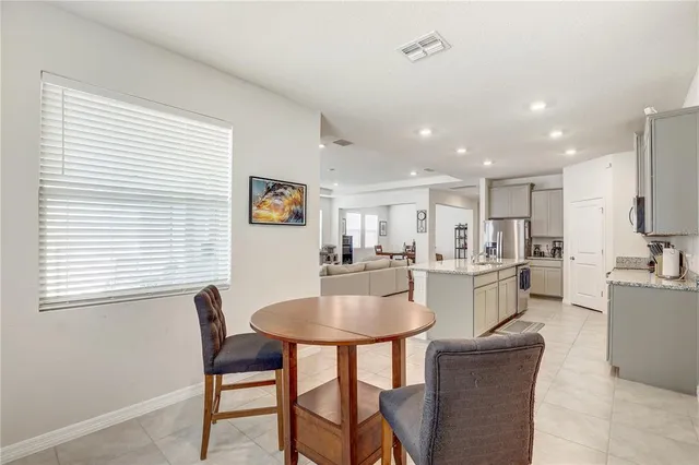 a view of a room with a table and chairs