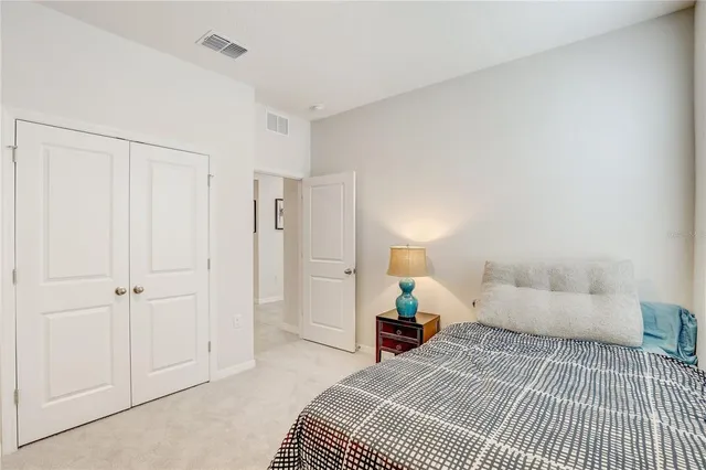 a bedroom with a bed and flat screen tv