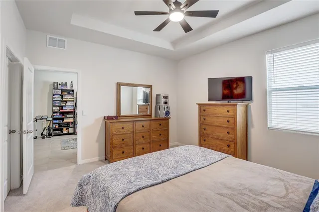 a living room with furniture a refrigerator and cabinets