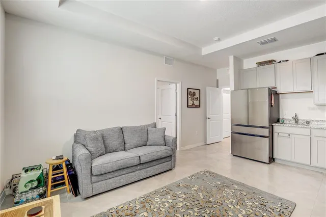 a kitchen with stainless steel appliances a refrigerator and wooden floor