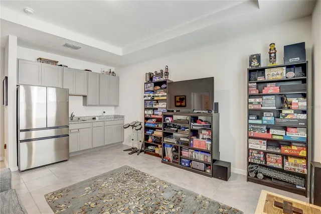 a living room with furniture and a book shelf