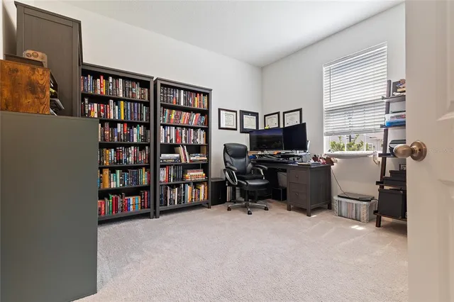 a large white kitchen with stainless steel appliances kitchen island granite countertop a large counter top a couches and cabinets