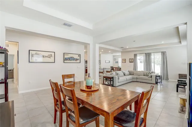 a dining room with furniture and a large window