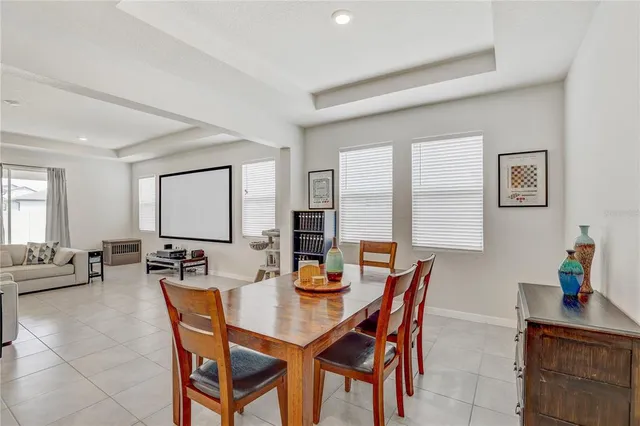 a dining room with furniture and a window
