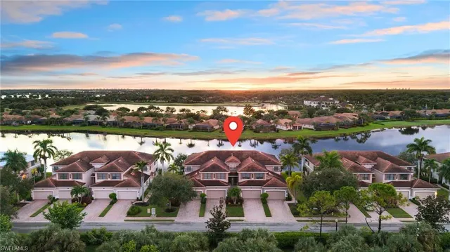 an aerial view of residential houses with outdoor space and ocean view
