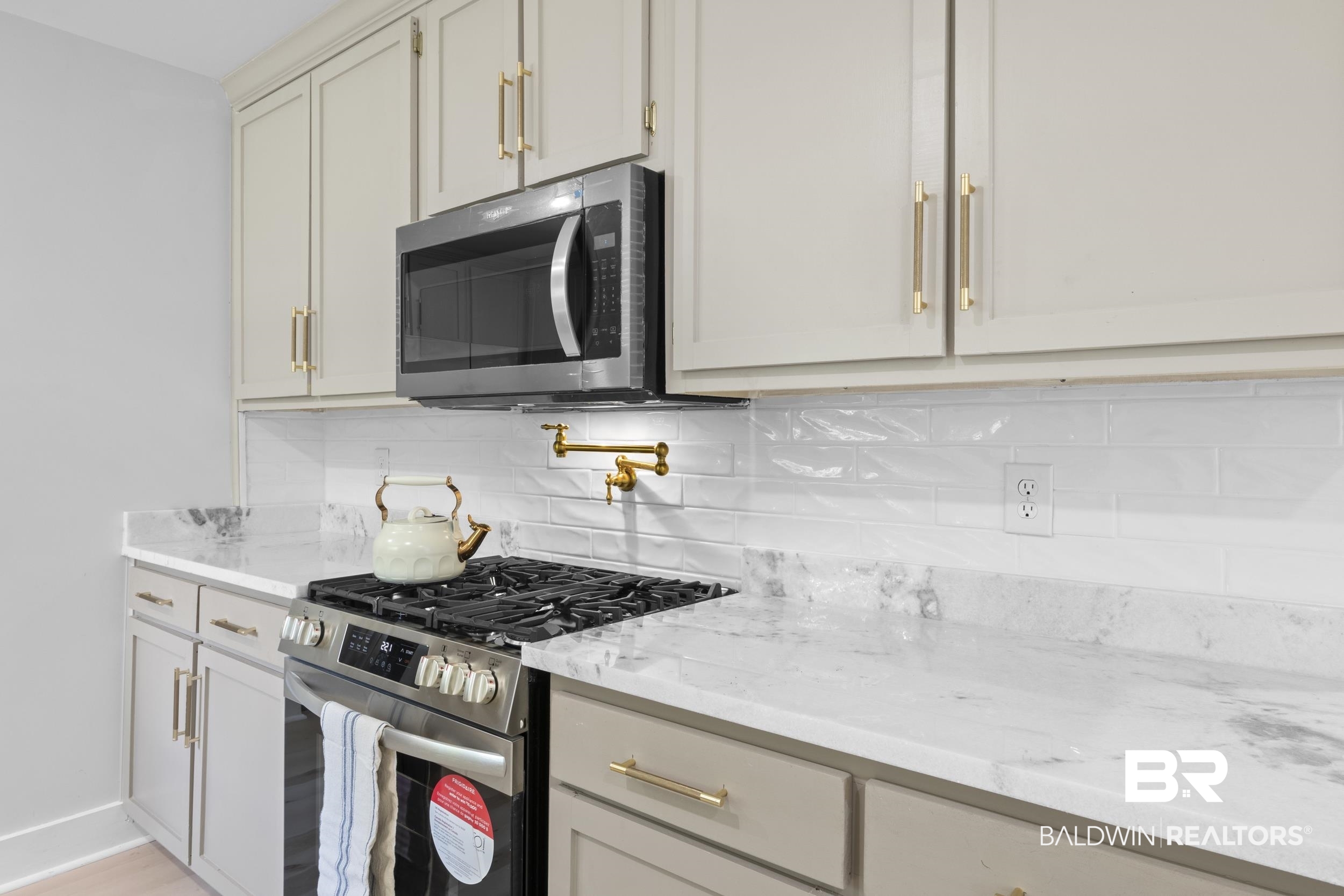 315 Park Avenue Mobile, AL 36607 - Photo 17 of 27 Kitchen with tasteful backsplash, stainless steel appliances, and light stone counters