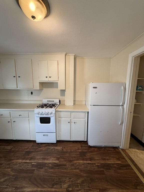 90 Bacon Street, Unit 1 Waltham, MA 02451 - Photo 2 of 9 a kitchen with cabinets appliances a sink and a stove