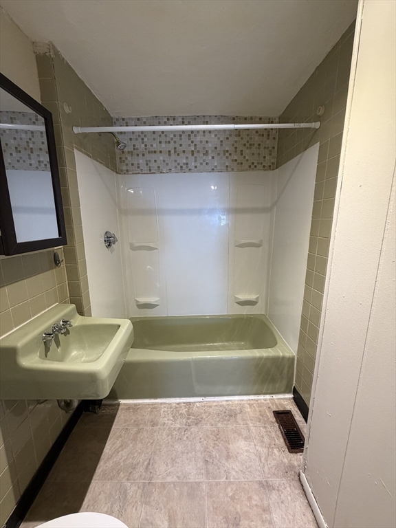 90 Bacon Street, Unit 1 Waltham, MA 02451 - Photo 8 of 9 a bathroom with a sink and a mirror