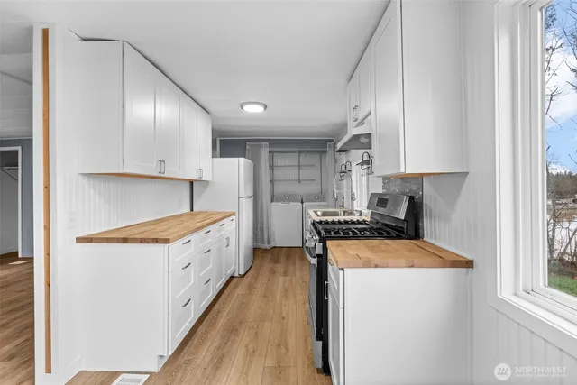 a kitchen with stainless steel appliances granite countertop a stove a sink and a refrigerator