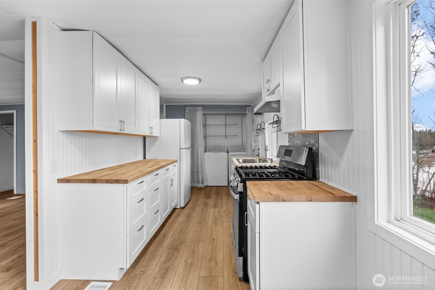 18818 Slough Lane Southeast Yelm, WA 98597 - Photo 11 of 39 a kitchen with stainless steel appliances granite countertop a stove a sink and a refrigerator