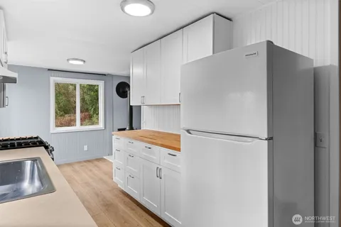 a kitchen with stainless steel appliances a refrigerator sink and stove