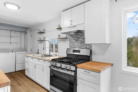 a kitchen with cabinets appliances and a window