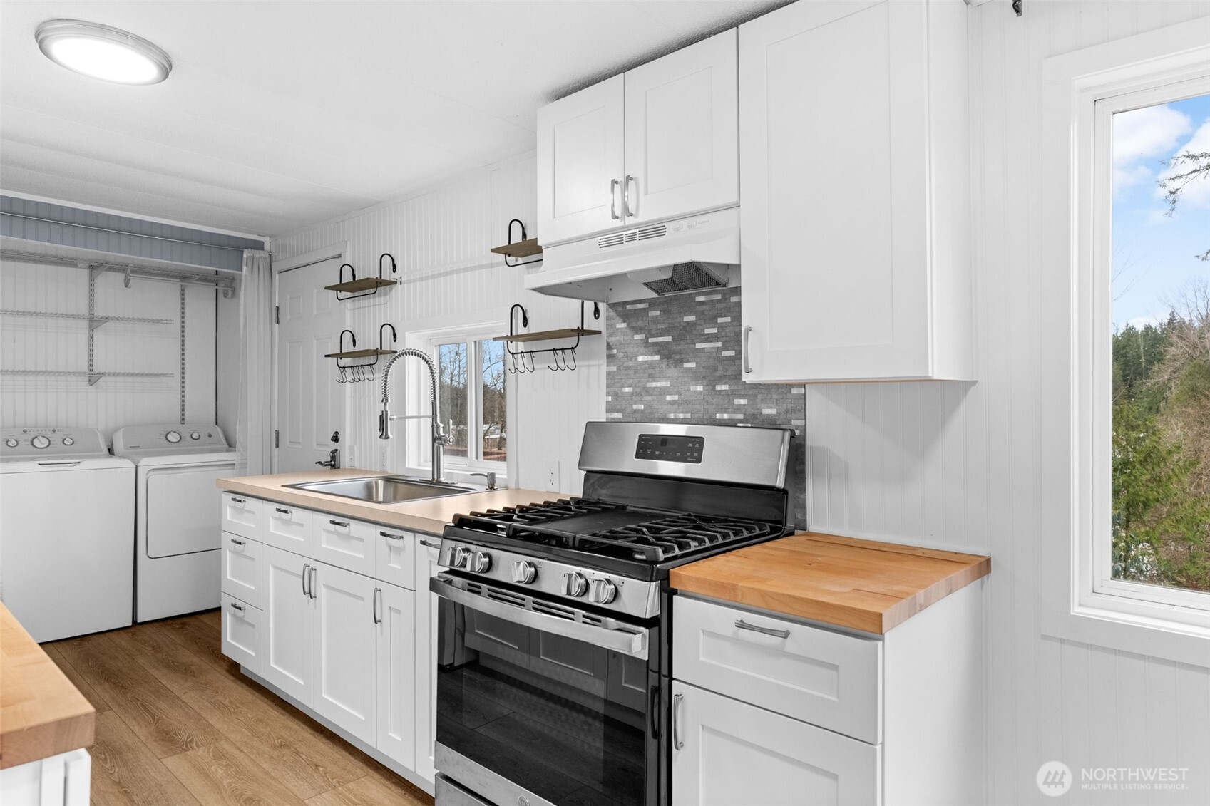 18818 Slough Lane Southeast Yelm, WA 98597 - Photo 13 of 39 a kitchen with cabinets appliances and a window