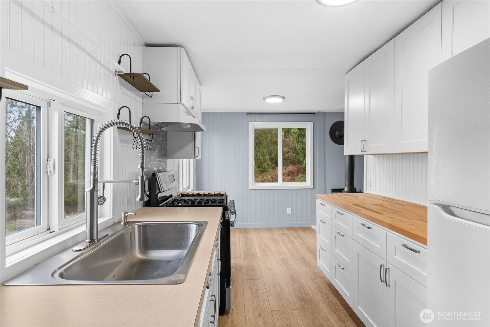 18818 Slough Lane Southeast Yelm, WA 98597 - Photo 14 of 39 a kitchen that has a sink a stove and window