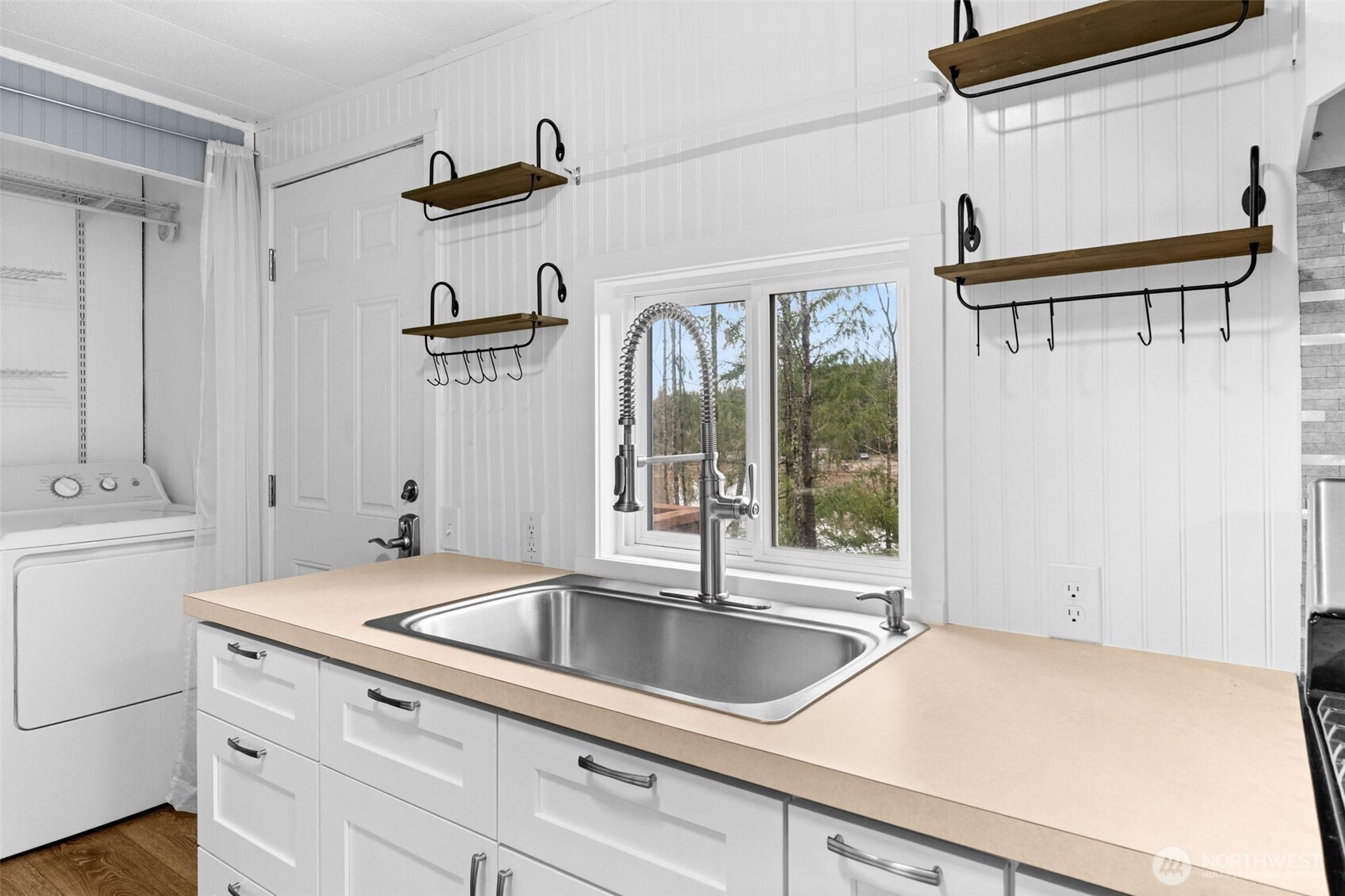 18818 Slough Lane Southeast Yelm, WA 98597 - Photo 15 of 39 a kitchen with a refrigerator a sink and cabinets