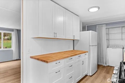 a kitchen with a refrigerator and a stove top oven