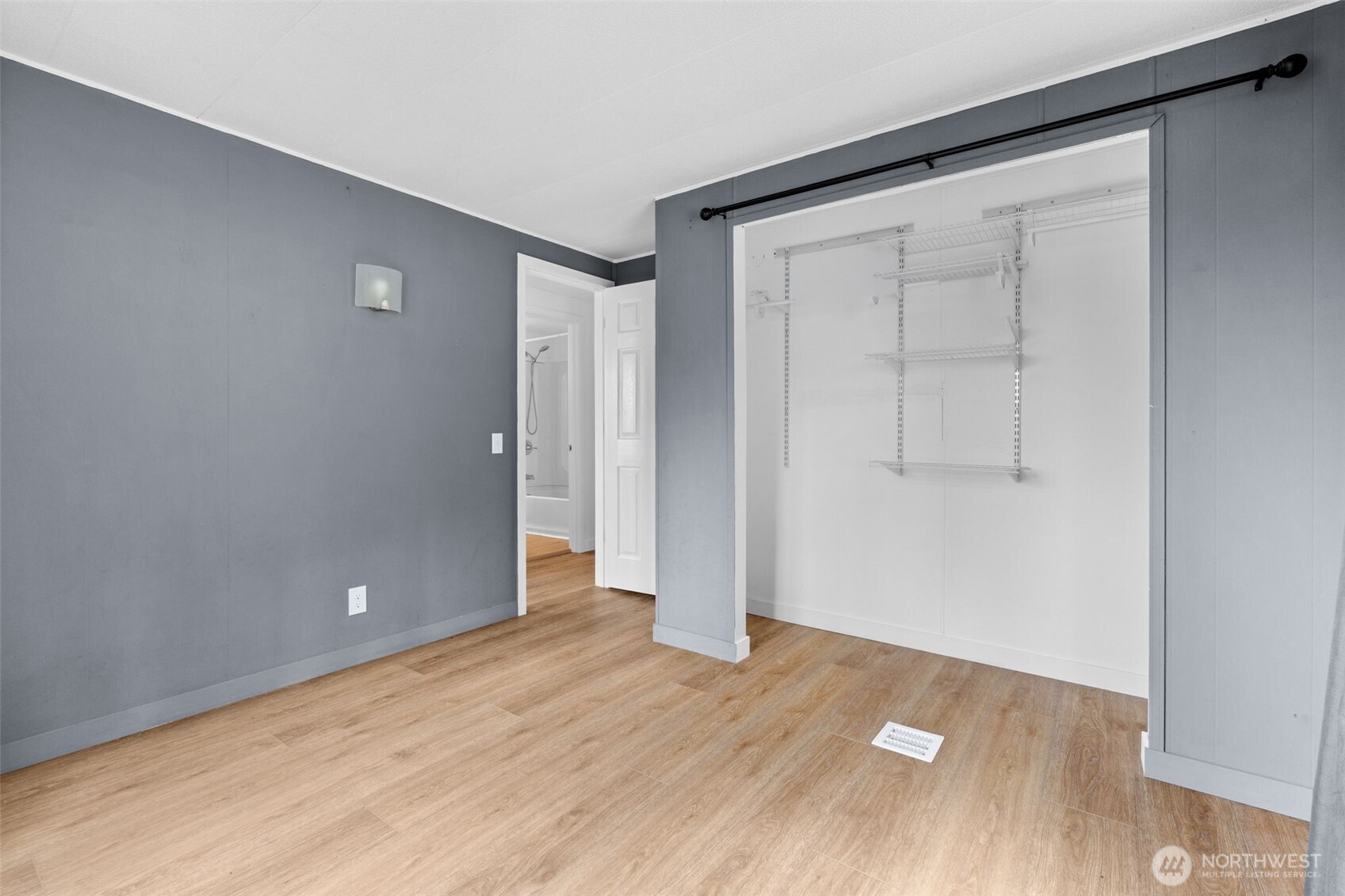 18818 Slough Lane Southeast Yelm, WA 98597 - Photo 17 of 39 an empty room with wooden floor and windows