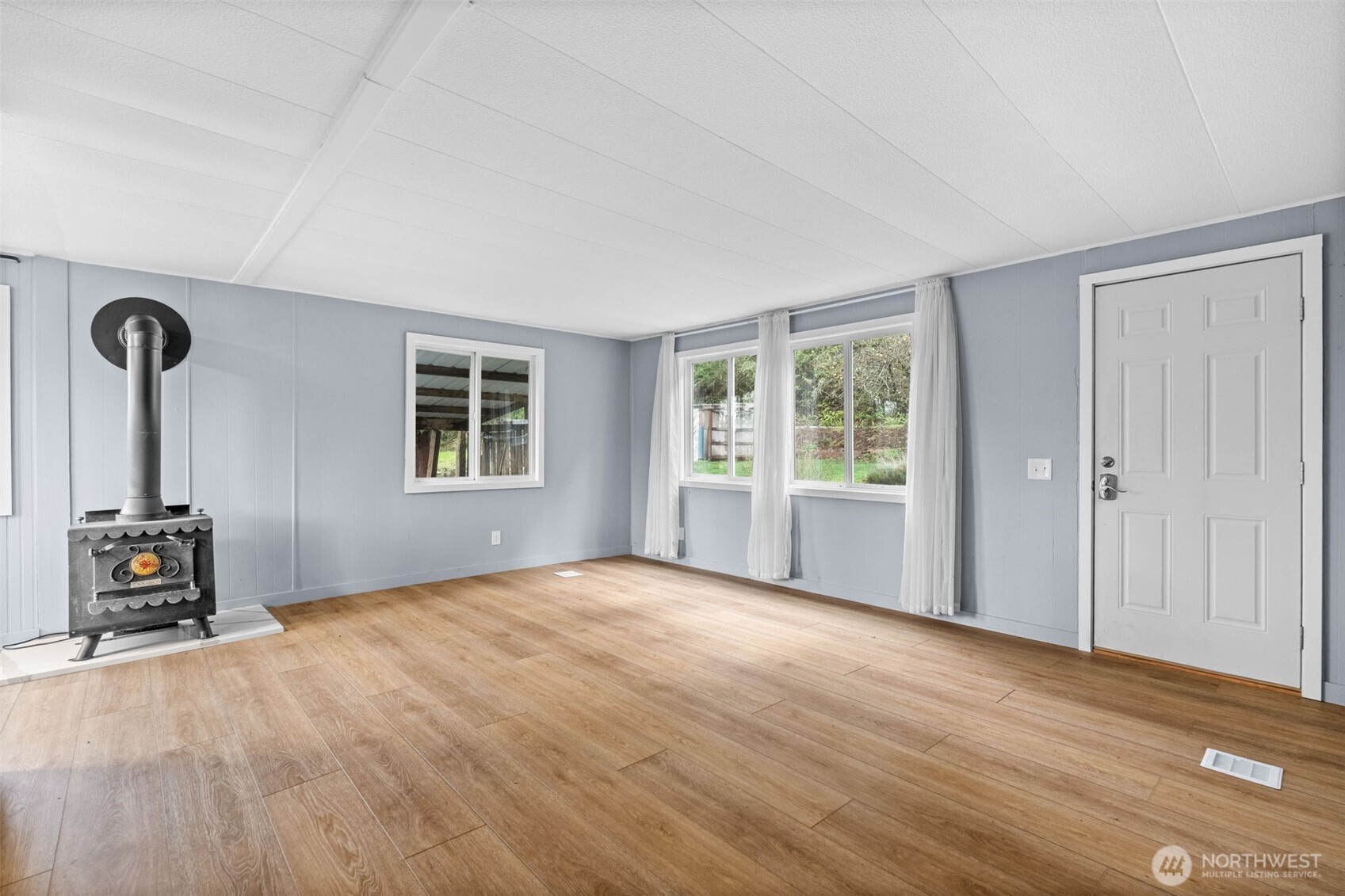 18818 Slough Lane Southeast Yelm, WA 98597 - Photo 5 of 39 a view of a livingroom with a window and wooden floor