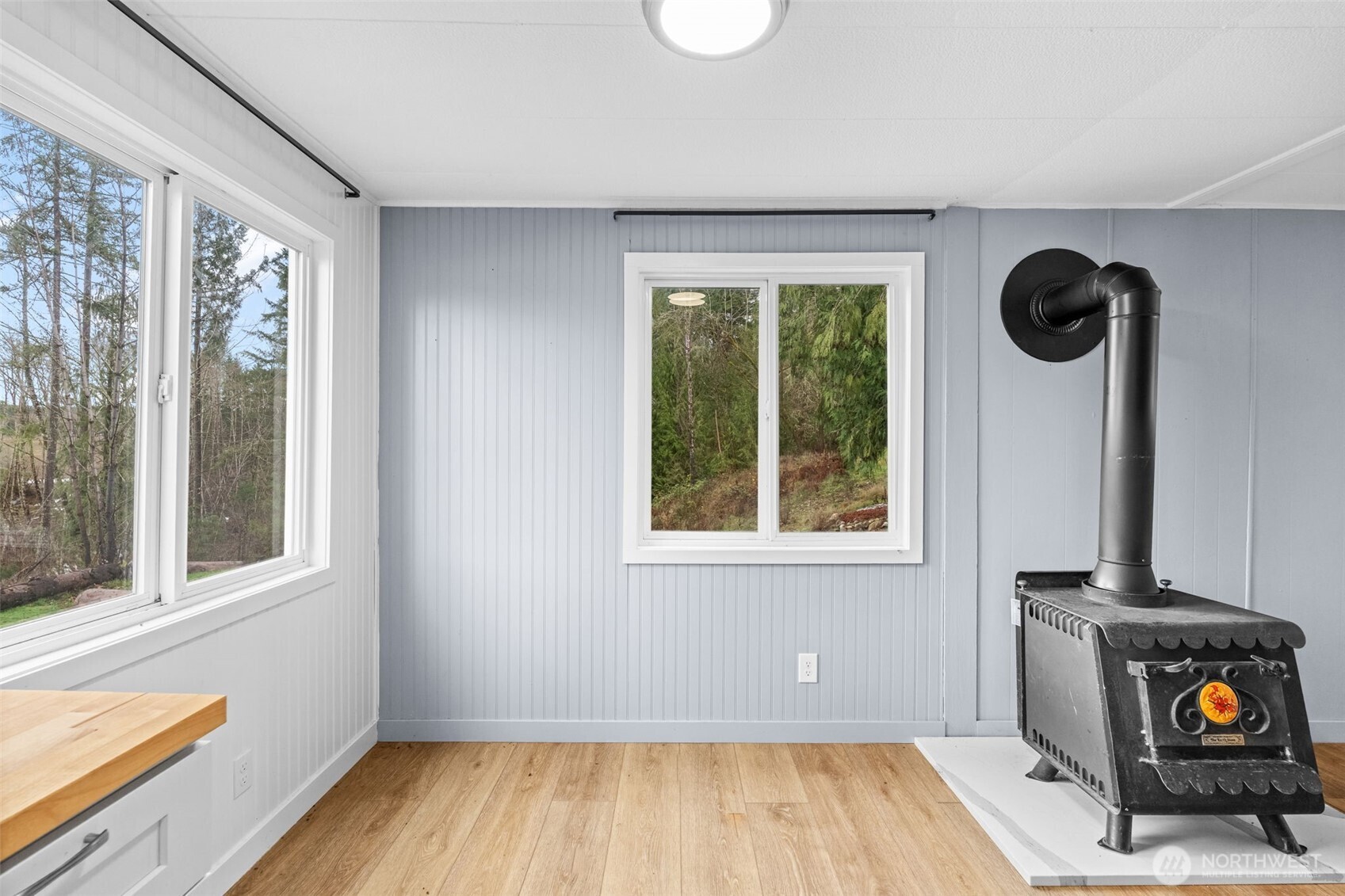 18818 Slough Lane Southeast Yelm, WA 98597 - Photo 6 of 39 a view of an empty room with a window and wooden floor