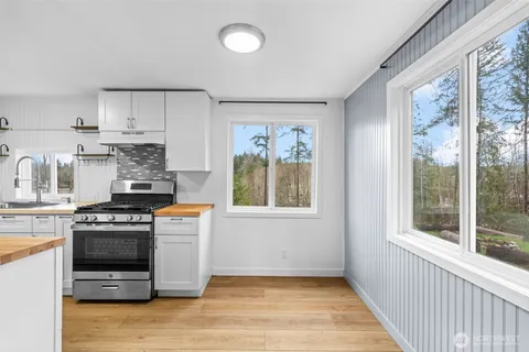 a kitchen with stainless steel appliances granite countertop a stove and a refrigerator