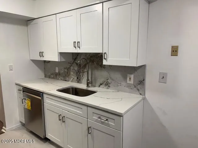 a view of a kitchen with sink and cabinets