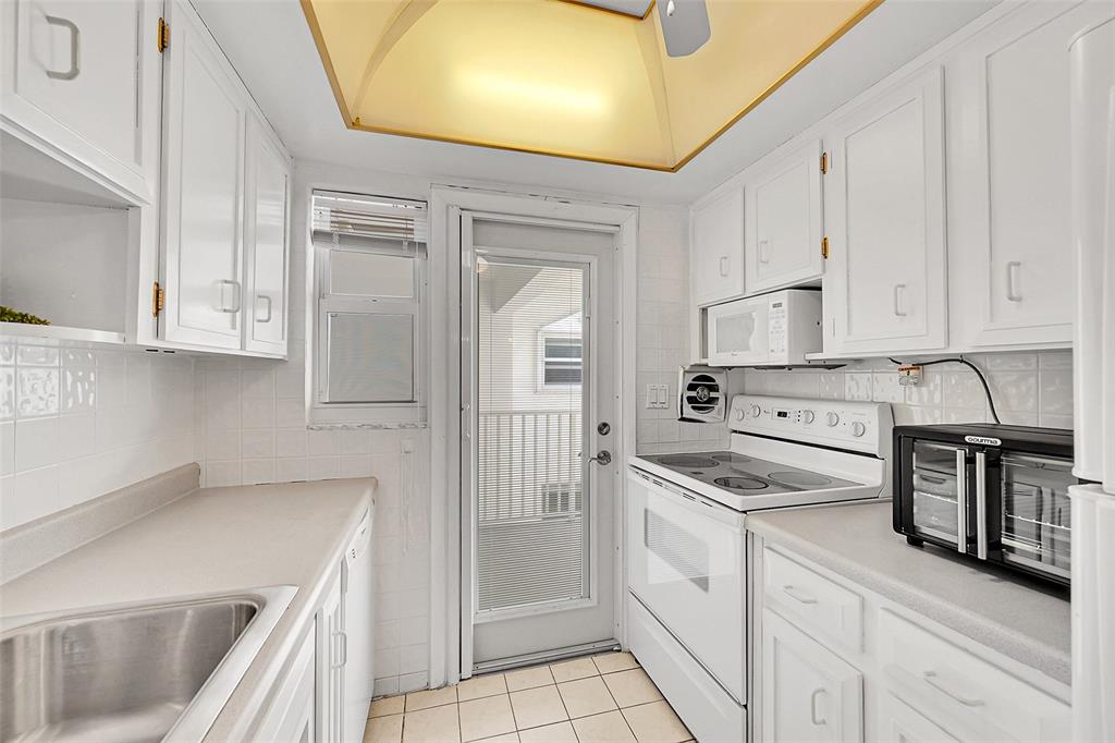 1110 North Riverside Drive, Unit 27 Pompano Beach, FL 33062 - Photo 29 of 52 Your Kitchen Features lots of Cupboard and Cabinet Space, is Bright & Has A Door to Your Balcony! Being Sold Furnished, Turn-Key. Impact Windows & Doors also include Blinds and Retractable Screen Doors!