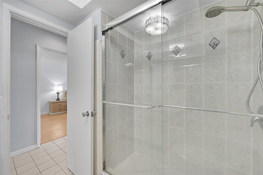 1110 North Riverside Drive, Unit 27 Pompano Beach, FL 33062 - Photo 39 of 52 Your Bathroom Has an Updated Glass Enclosed Shower, Huge Custom Mirror, Built-In Hamper, Wall Heater and lots of Storage Cabinets and Countertops.